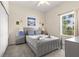 Serene bedroom with a gray bed, soft linens, and a window letting in natural light at 110 Watling Way # 25204, Davenport, FL 33837
