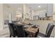 Elegant dining area with seating for six, modern decor and adjacent living space at 110 Watling Way # 25204, Davenport, FL 33837
