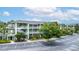 Exterior view of a multi-story condo building with parking, landscaping, and balconies at 110 Watling Way # 25204, Davenport, FL 33837