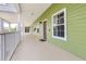 Exterior walkway showing light green siding, white railings, and brown doors with secure residential living at 110 Watling Way # 25204, Davenport, FL 33837