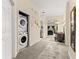 Inviting home hallway featuring a laundry closet and flows into living space with carpet flooring at 110 Watling Way # 25204, Davenport, FL 33837