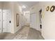 Hallway with neutral tones, carpet flooring, and multiple doors to other rooms, offering a welcoming entry at 110 Watling Way # 25204, Davenport, FL 33837