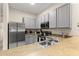 Contemporary kitchen design boasts stainless steel appliances, gray cabinetry and modern sink at 110 Watling Way # 25204, Davenport, FL 33837