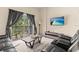 Relaxing living room with plush seating, sliding glass doors, balcony and entertainment center at 110 Watling Way # 25204, Davenport, FL 33837