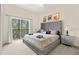 Serene main bedroom with a king-sized bed, balcony access, and stylish furnishings at 110 Watling Way # 25204, Davenport, FL 33837