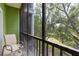 Relaxing screened patio with a table and chairs overlooking a lush green space at 110 Watling Way # 25204, Davenport, FL 33837