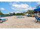 Resort-style pool area with a hot tub surrounded by lounge chairs and umbrellas at 110 Watling Way # 25204, Davenport, FL 33837
