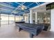 Community recreation area with pool tables and seating under covered patio at 110 Watling Way # 25204, Davenport, FL 33837