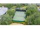 Aerial shot of a professionally maintained tennis court surrounded by lush landscaping at 110 Watling Way # 25204, Davenport, FL 33837