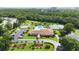 Aerial view of the community center, showcasing the pool, tennis courts, and beautiful green surroundings at 11412 Stamfield Dr, Orlando, FL 32821