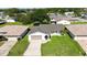 Aerial view of home showcasing well-manicured lawn, landscaping, and paved driveway at 11412 Stamfield Dr, Orlando, FL 32821