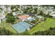 Aerial view of community tennis courts, pool, clubhouse, and landscaping at 11412 Stamfield Dr, Orlando, FL 32821