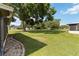 Lush backyard with mature trees and well-maintained lawn creating a private oasis at 11412 Stamfield Dr, Orlando, FL 32821