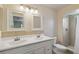 Bright bathroom with double sinks, two mirrors, and a glass-enclosed shower at 11412 Stamfield Dr, Orlando, FL 32821
