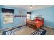 Blue themed bedroom with matching carpet, ceiling fan, and a wooden bed frame at 11412 Stamfield Dr, Orlando, FL 32821