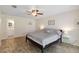 Well-lit bedroom with tile floors, ceiling fan, and access to an ensuite bathroom at 11412 Stamfield Dr, Orlando, FL 32821
