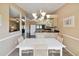 Charming dining area with a chandelier adjacent to the kitchen and living room at 11412 Stamfield Dr, Orlando, FL 32821