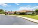 Community clubhouse with a covered entrance, well-manicured lawn, and mature landscaping at 11412 Stamfield Dr, Orlando, FL 32821