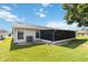 Rear exterior view featuring screened porch and an HVAC system at 11412 Stamfield Dr, Orlando, FL 32821
