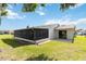 Exterior view with screened-in porch, sliding glass doors and well manicured lawn at 11412 Stamfield Dr, Orlando, FL 32821