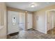 Bright foyer with tile flooring features an ornate door, a storm door, and neutral decor at 11412 Stamfield Dr, Orlando, FL 32821
