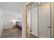 Hallway view of bedroom and bathroom with tile floors and neutral paint at 11412 Stamfield Dr, Orlando, FL 32821
