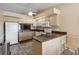 Functional kitchen with appliances, a ceiling fan, and a breakfast bar at 11412 Stamfield Dr, Orlando, FL 32821