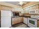 Bright kitchen with white appliances, ample cabinet space, and a functional layout at 11412 Stamfield Dr, Orlando, FL 32821