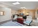 Spacious living room with neutral walls, tile floors, skylights and comfortable furniture at 11412 Stamfield Dr, Orlando, FL 32821