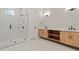 Modern bathroom with a glass enclosed shower and double sink vanity with wooden cabinets at 1217 Cloverlawn Ave, Orlando, FL 32806