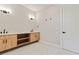 Bright bathroom features a dual sink vanity with open shelves and modern fixtures at 1217 Cloverlawn Ave, Orlando, FL 32806