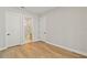 Bedroom showcasing an ensuite bathroom, ample space, and hardwood flooring at 1217 Cloverlawn Ave, Orlando, FL 32806