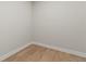 An empty closet shows light hardwood floors, neutral colored walls, and white trim at 1217 Cloverlawn Ave, Orlando, FL 32806