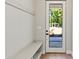 Mud room with bench seating and a view to the front yard at 1217 Cloverlawn Ave, Orlando, FL 32806