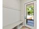 Bright entryway with storage bench and coat rack offering a welcoming transition space at 1217 Cloverlawn Ave, Orlando, FL 32806