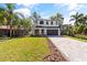 Charming two-story home with a well-manicured lawn and paver driveway at 1217 Cloverlawn Ave, Orlando, FL 32806
