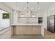 Spacious kitchen featuring a large center island, modern lighting, and stainless-steel appliances at 1217 Cloverlawn Ave, Orlando, FL 32806