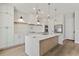 Well-lit kitchen showcasing a center island, white cabinets, and stainless-steel appliances at 1217 Cloverlawn Ave, Orlando, FL 32806