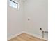 Dedicated laundry room with utility connections, natural light, and hardwood floors at 1217 Cloverlawn Ave, Orlando, FL 32806