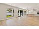Open living room with hardwood floors and views of the kitchen and backyard at 1217 Cloverlawn Ave, Orlando, FL 32806