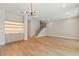 Open living space featuring custom built-in shelving, hardwood floors, and a staircase at 1217 Cloverlawn Ave, Orlando, FL 32806