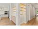 View of lit shelving with modern kitchen in background at 1217 Cloverlawn Ave, Orlando, FL 32806