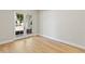 Bright and airy living room showcasing beautiful hardwood floors and natural light through French doors at 1217 Cloverlawn Ave, Orlando, FL 32806