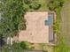 Aerial view showcases the home's roof, pool, and surrounding trees at 1319 Johns Cove Ln, Oakland, FL 34787