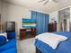 Serene bedroom featuring carpet, large windows, a sofa, and cozy decorative touches at 1319 Johns Cove Ln, Oakland, FL 34787