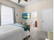 Bright bedroom with ensuite bathroom and a large window for natural light at 1319 Johns Cove Ln, Oakland, FL 34787