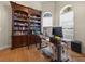 Charming office with a large bookshelf, built-in ladder, wood floors, and lots of natural light at 1319 Johns Cove Ln, Oakland, FL 34787
