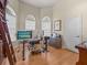 Home office with wood floors, two windows with blinds, and a built-in ladder to the bookshelf at 1319 Johns Cove Ln, Oakland, FL 34787