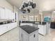 Bright kitchen boasting granite countertops, white cabinets, stainless appliances, and a center island at 1319 Johns Cove Ln, Oakland, FL 34787