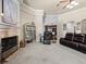 Cozy living room boasts a fireplace, carpeted floors, a wet bar, and comfortable seating at 1319 Johns Cove Ln, Oakland, FL 34787